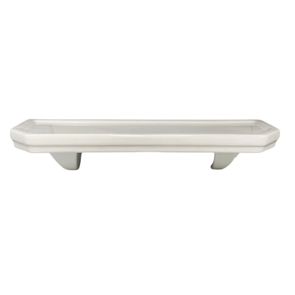 White ceramic planter with decorative feet on a white background