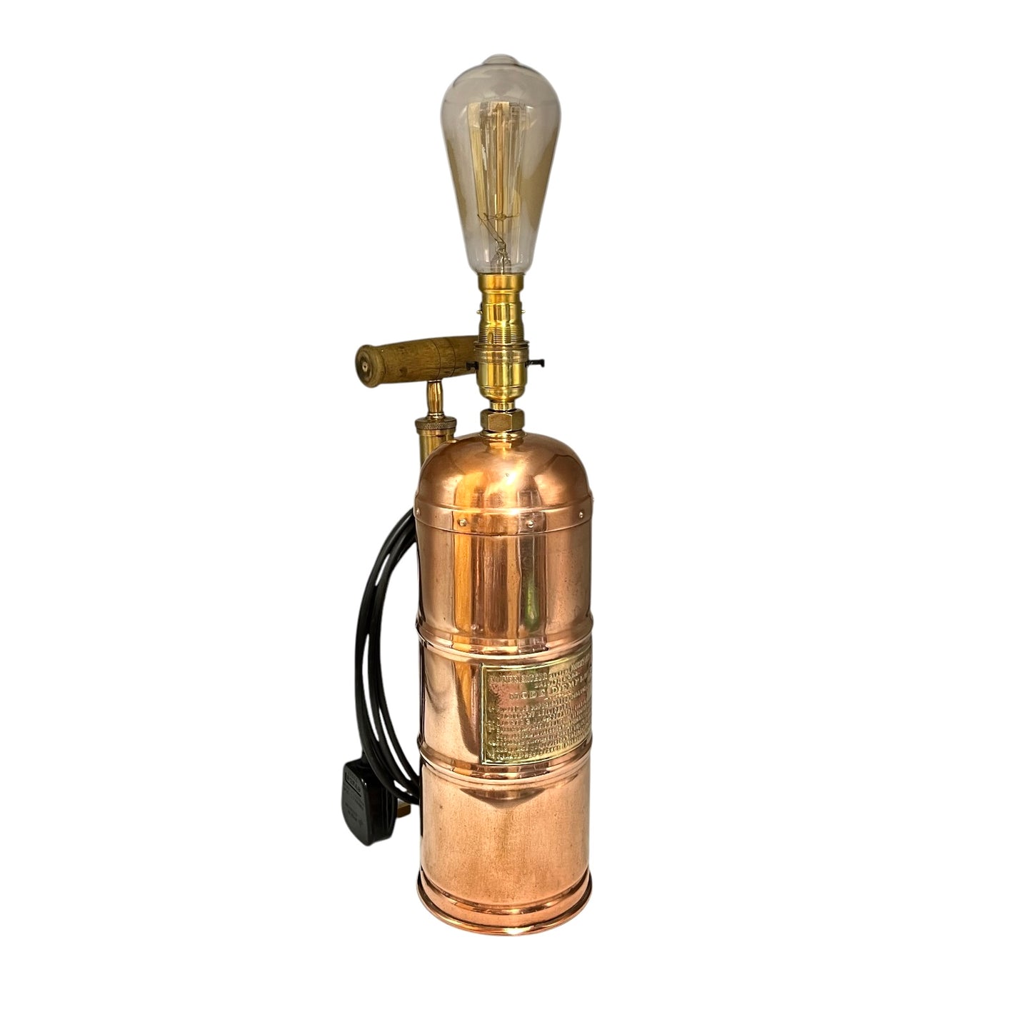 Copper and brass vintage-style lamp with a light bulb on a white background