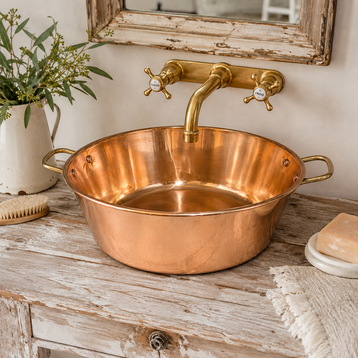 French copper up cycled bathroom sink with brass handles. Shown on a rustic bathroom vanity with a brass tap