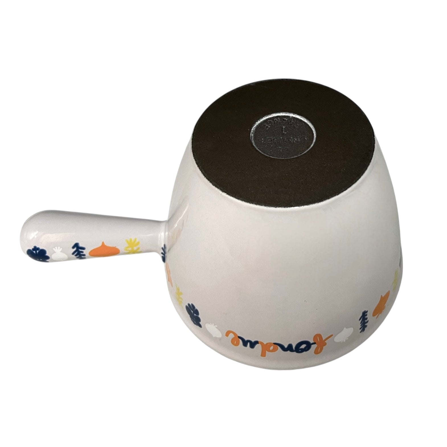 Le Creuset fondue pan on a white background