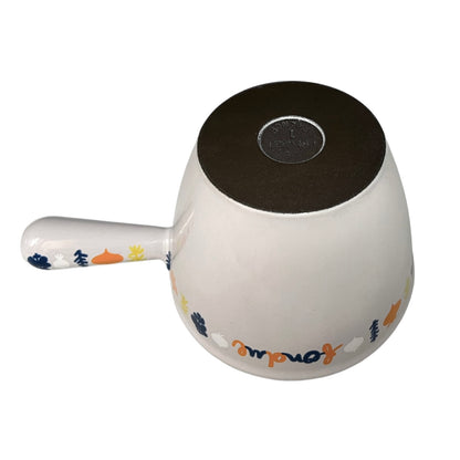 Le Creuset fondue pan on a white background