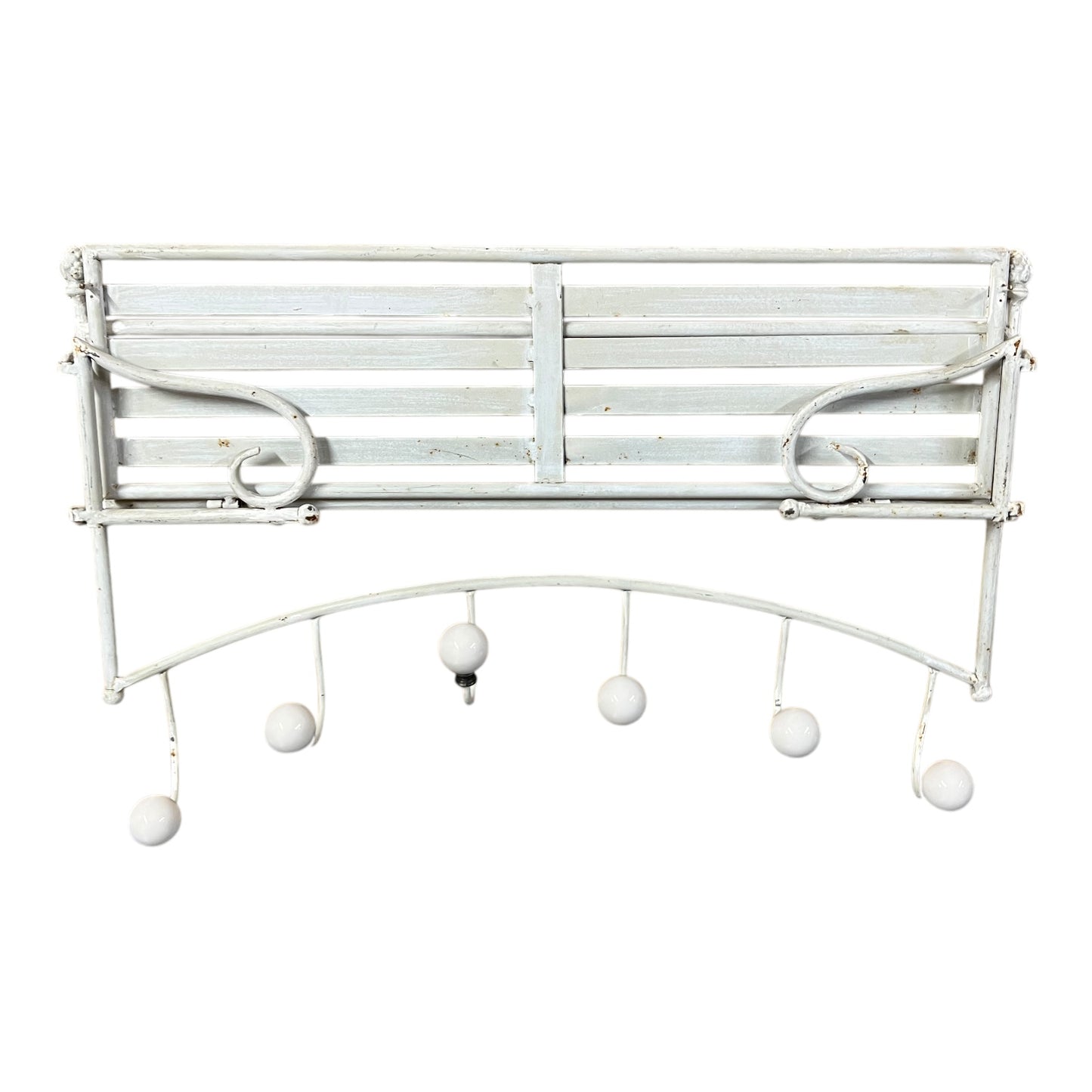 White metal wall-mounted coat rack with hanging balls on a white background