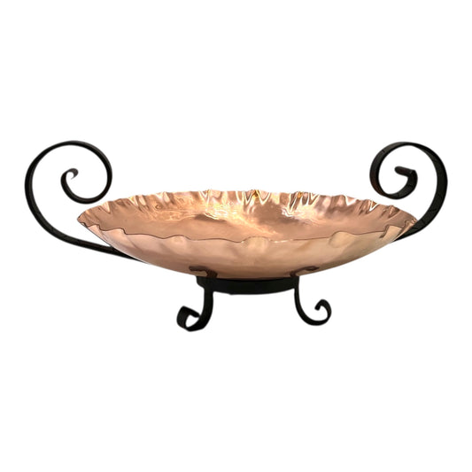 Copper bowl with black metal stand on a white background