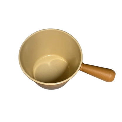 Brown Le Creuset vintage saucepan with handle on a white background