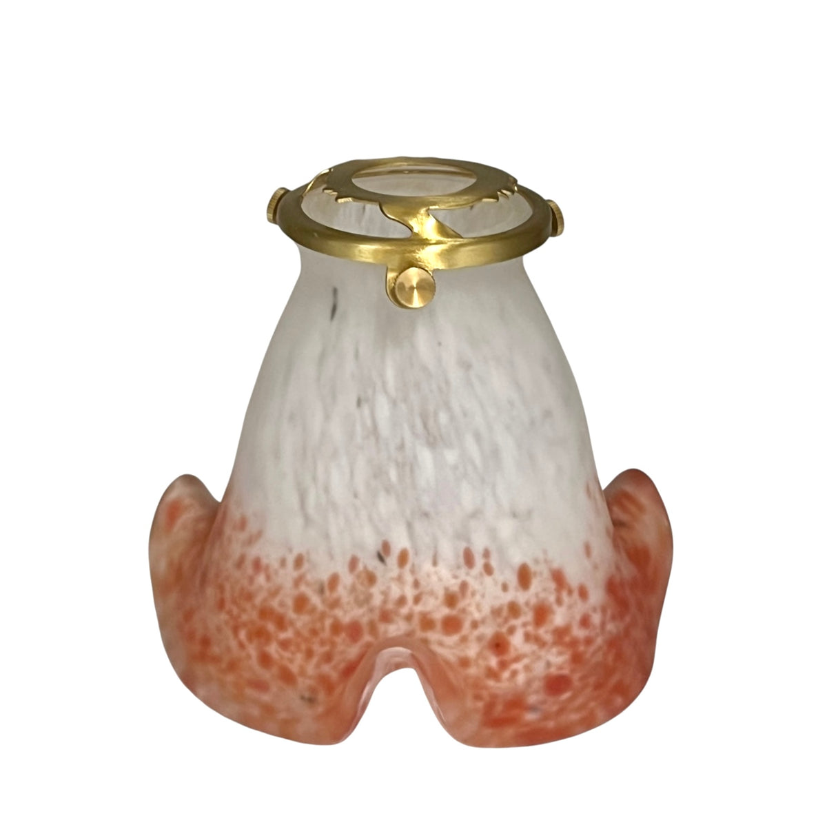 Bell shaped mottled coral coloured glass lampshade with a brass collar shown on a white background 