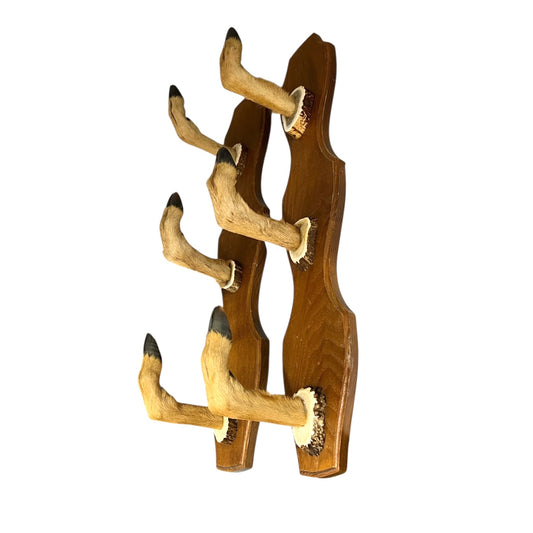 Two wooden wall hooks with deer hoof designs on a white background
