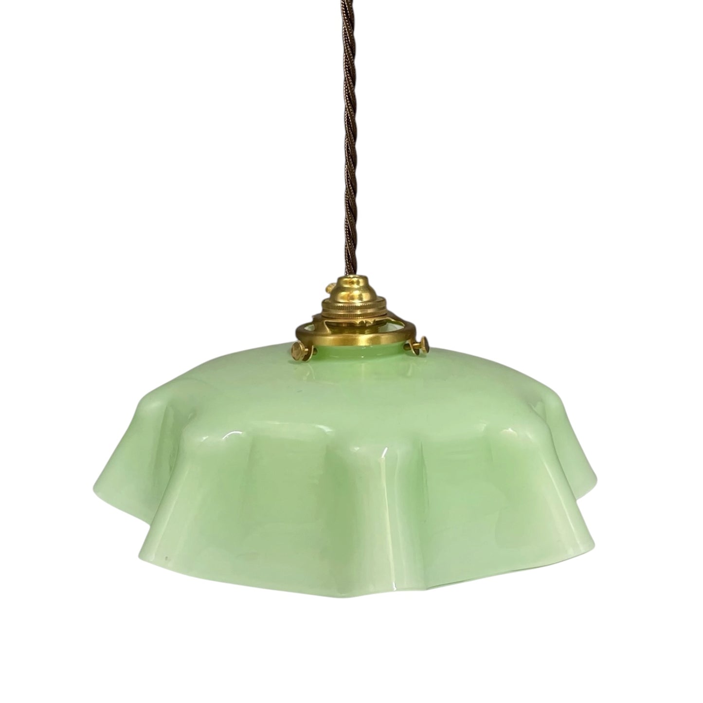 A vintage-style pendant light with a light green glass shade, a brass metal fixture, and a dark brown hanging cord, shown against a plain white background.
