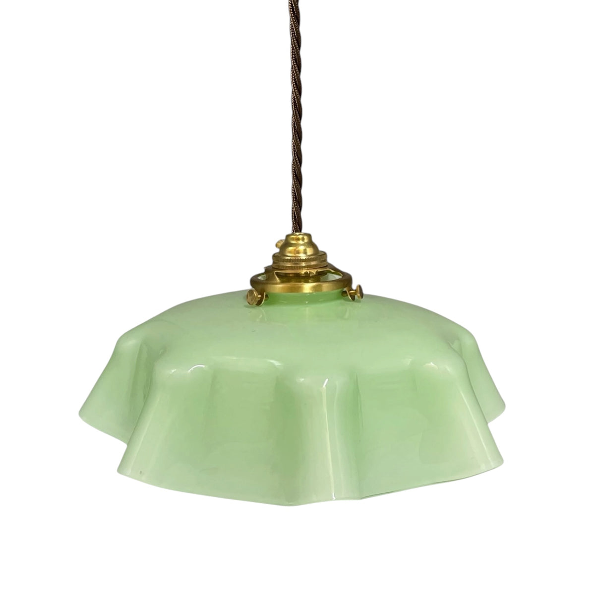 A vintage-style pendant light with a light green glass shade, a brass metal fixture, and a dark brown hanging cord, shown against a plain white background.