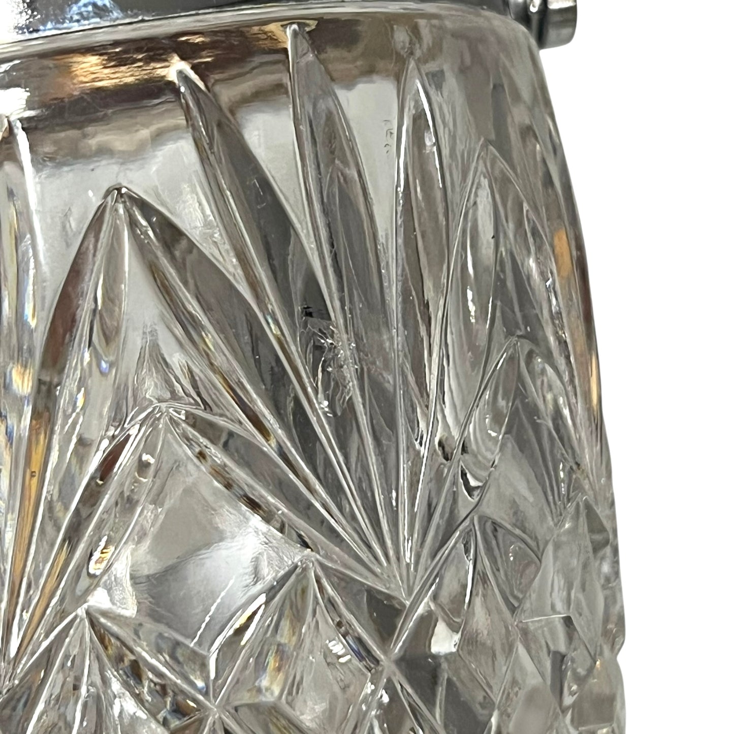 Close up of a French vintage glass ice bucket with silver rim on a white background