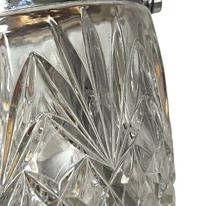 Close up of a French vintage glass ice bucket with silver rim on a white background