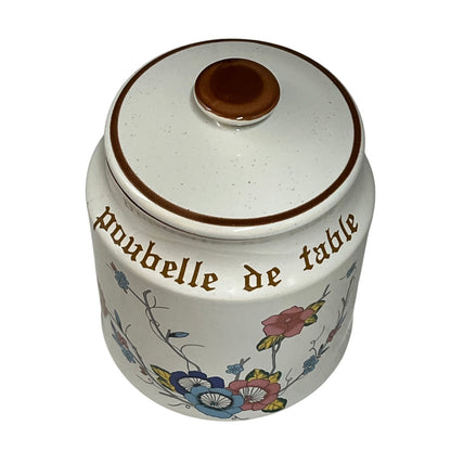 Decorative kitchen canister with floral designs, a lid and text Poubelle de Table on a white background