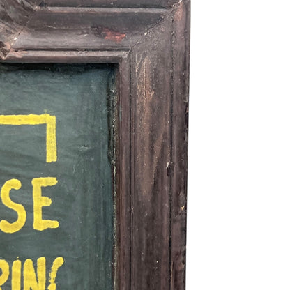 Corner of a framed picture with a dark brown frame and green interior.