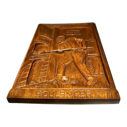 J.C. Lardeux signature on a wooden painting  titled Boulanger on a white background