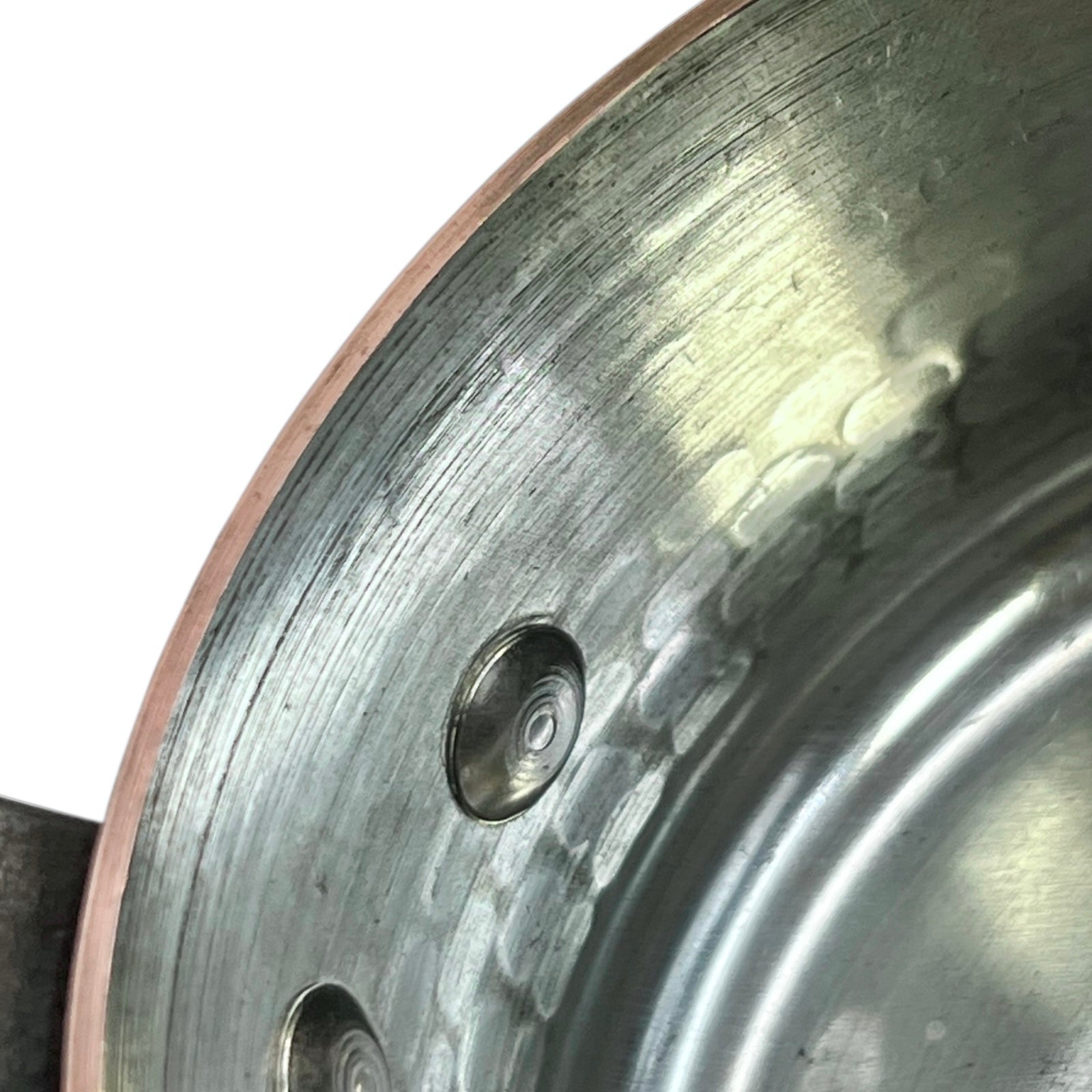 close up of copper pan tin lining and rim