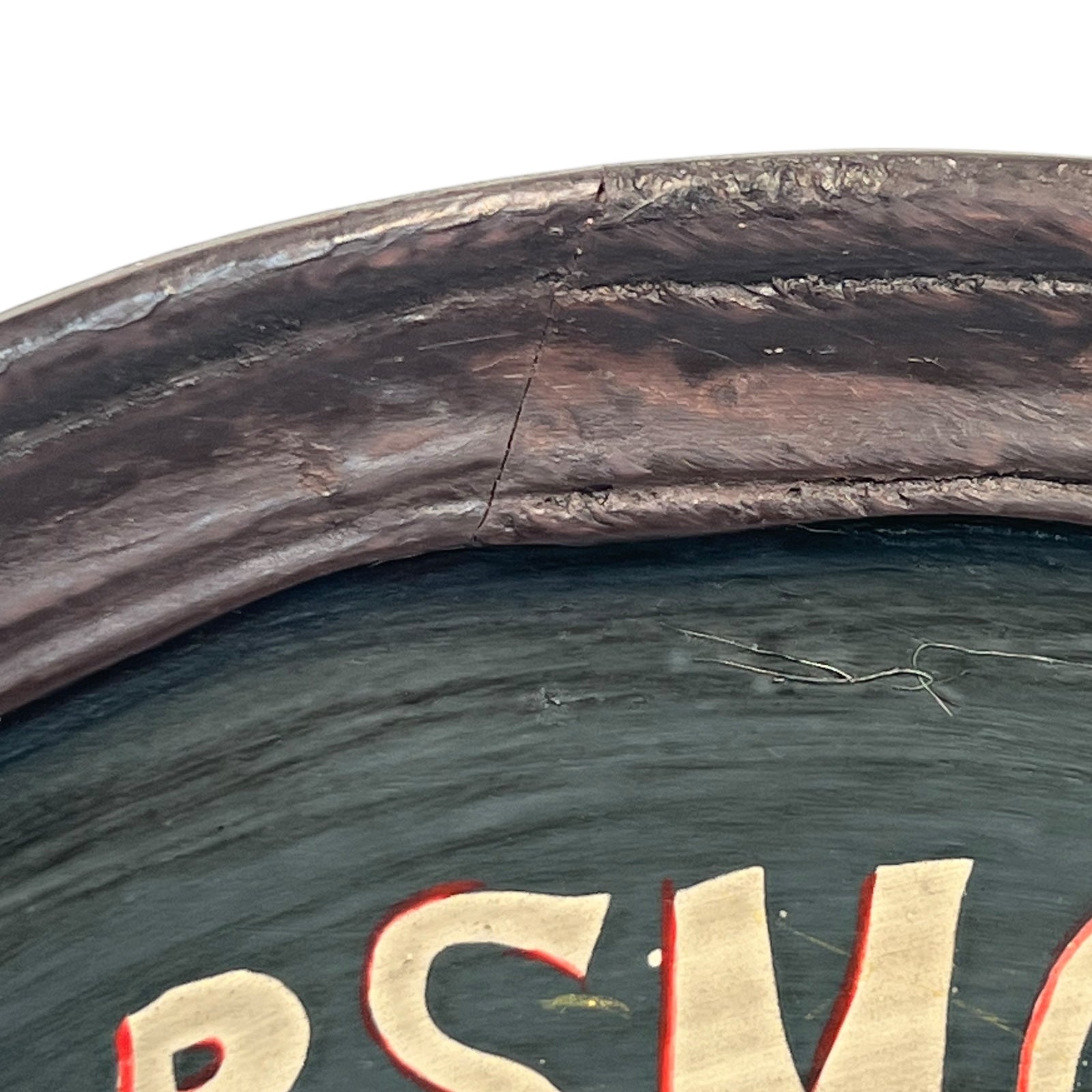 Corner of a framed picture with a dark brown frame and green interior.