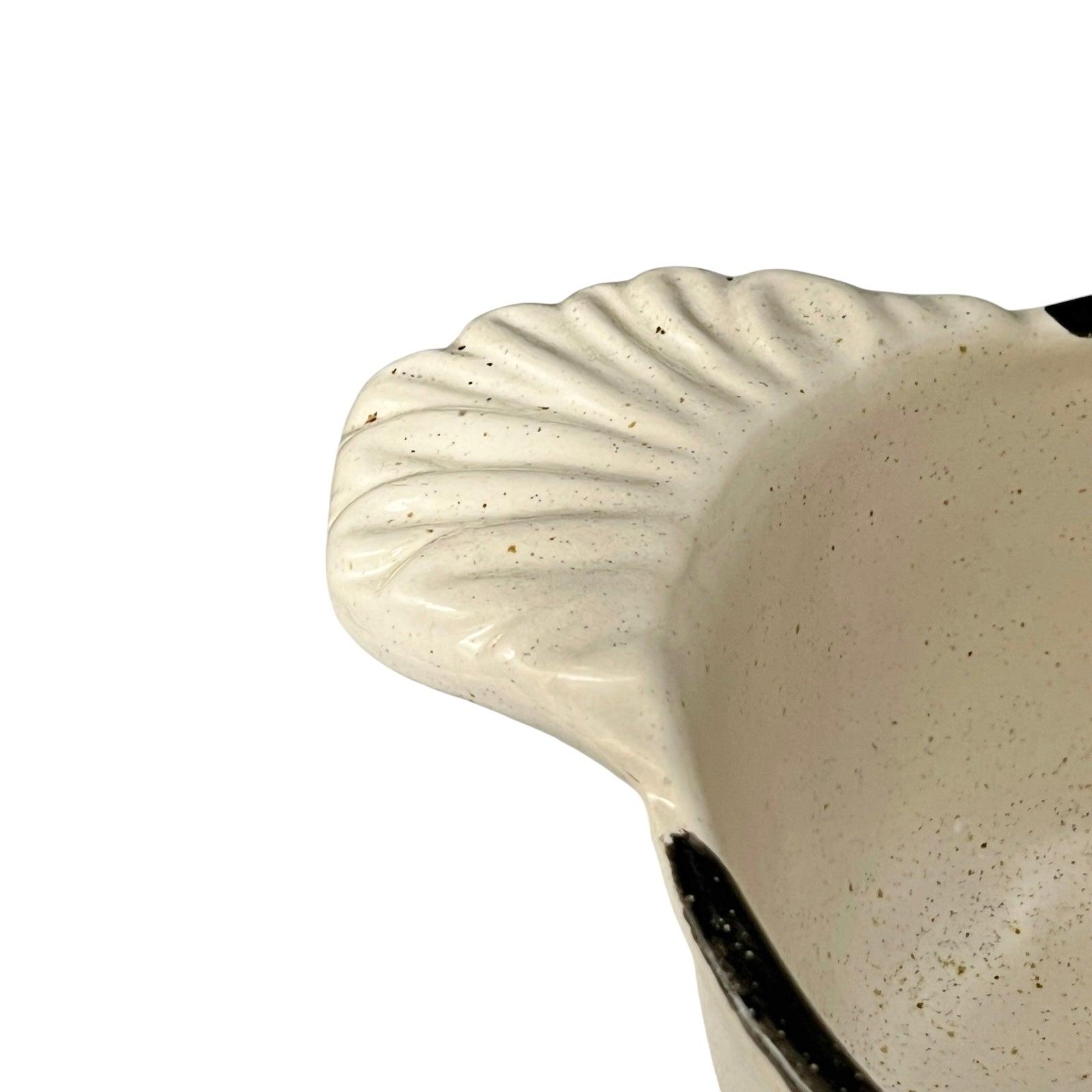 Close-up of a ceramic dish with textured edge on a white background