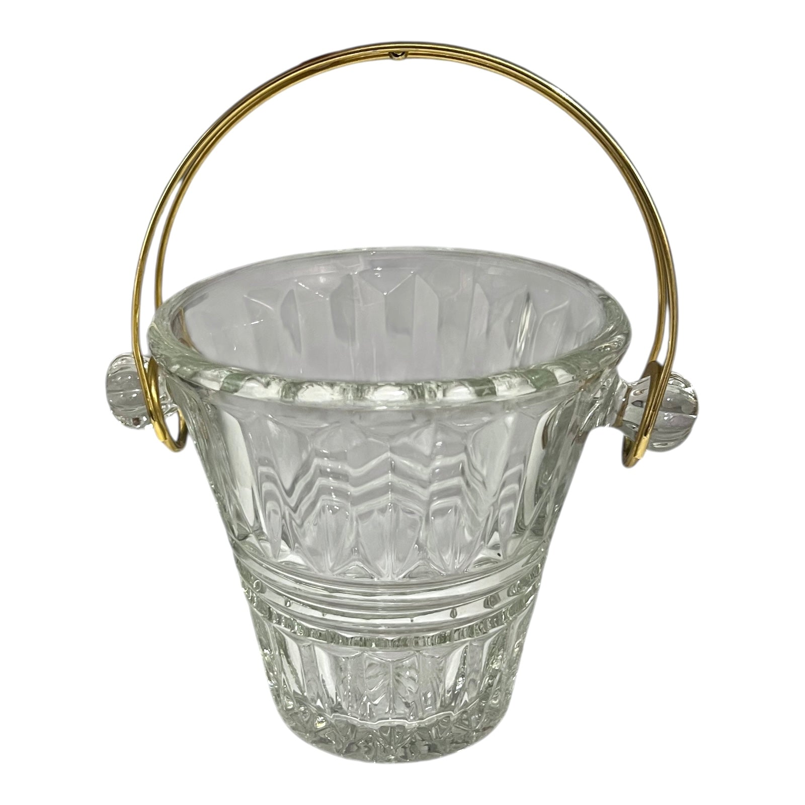 Clear glass ice bucket with gold handle on a white background