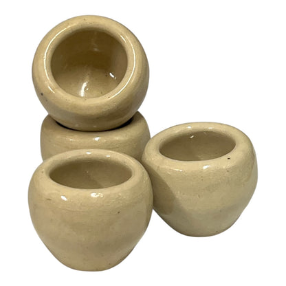 Set of beige ceramic escargots snail cups on a white background