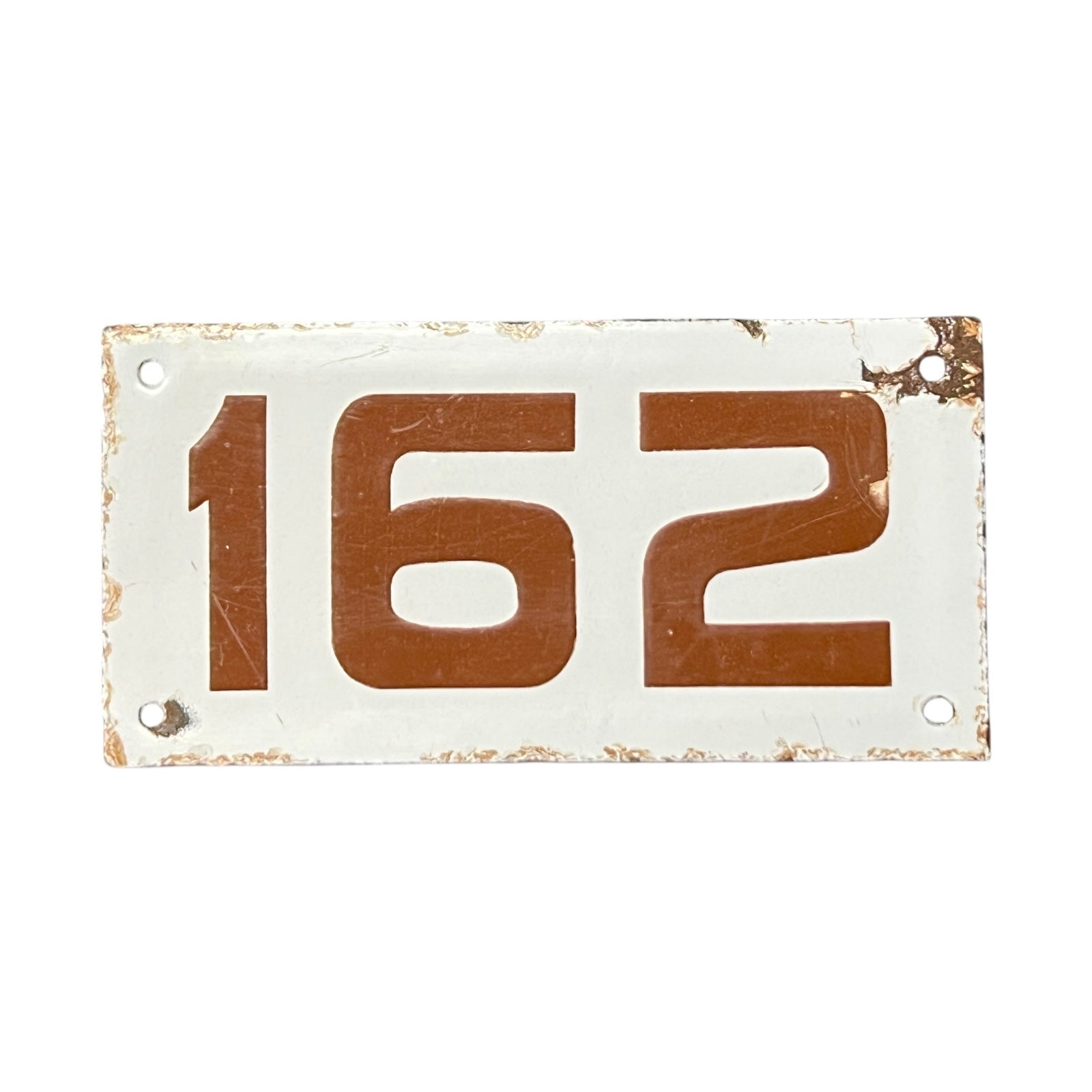 Rectangular metal plate with brown numbers '162' on a white background