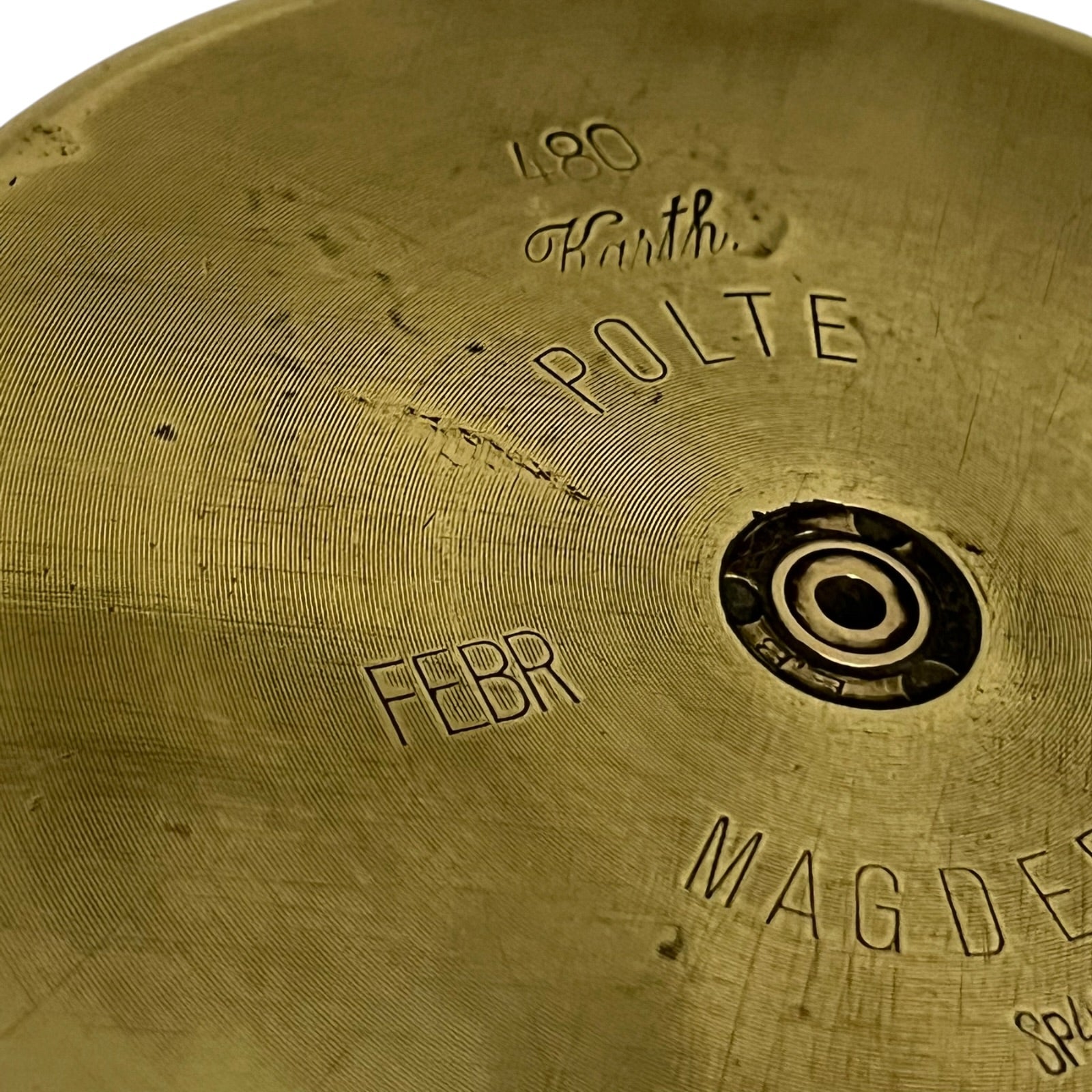 Close up of a brass WW1 German shell case on a white background