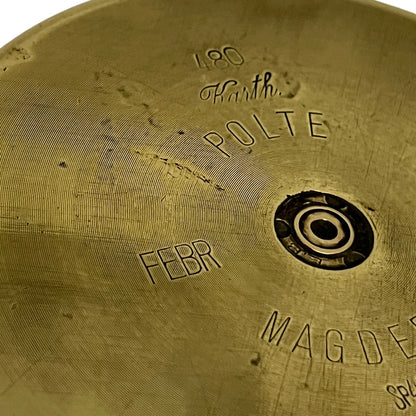 Close up of a brass WW1 German shell case on a white background
