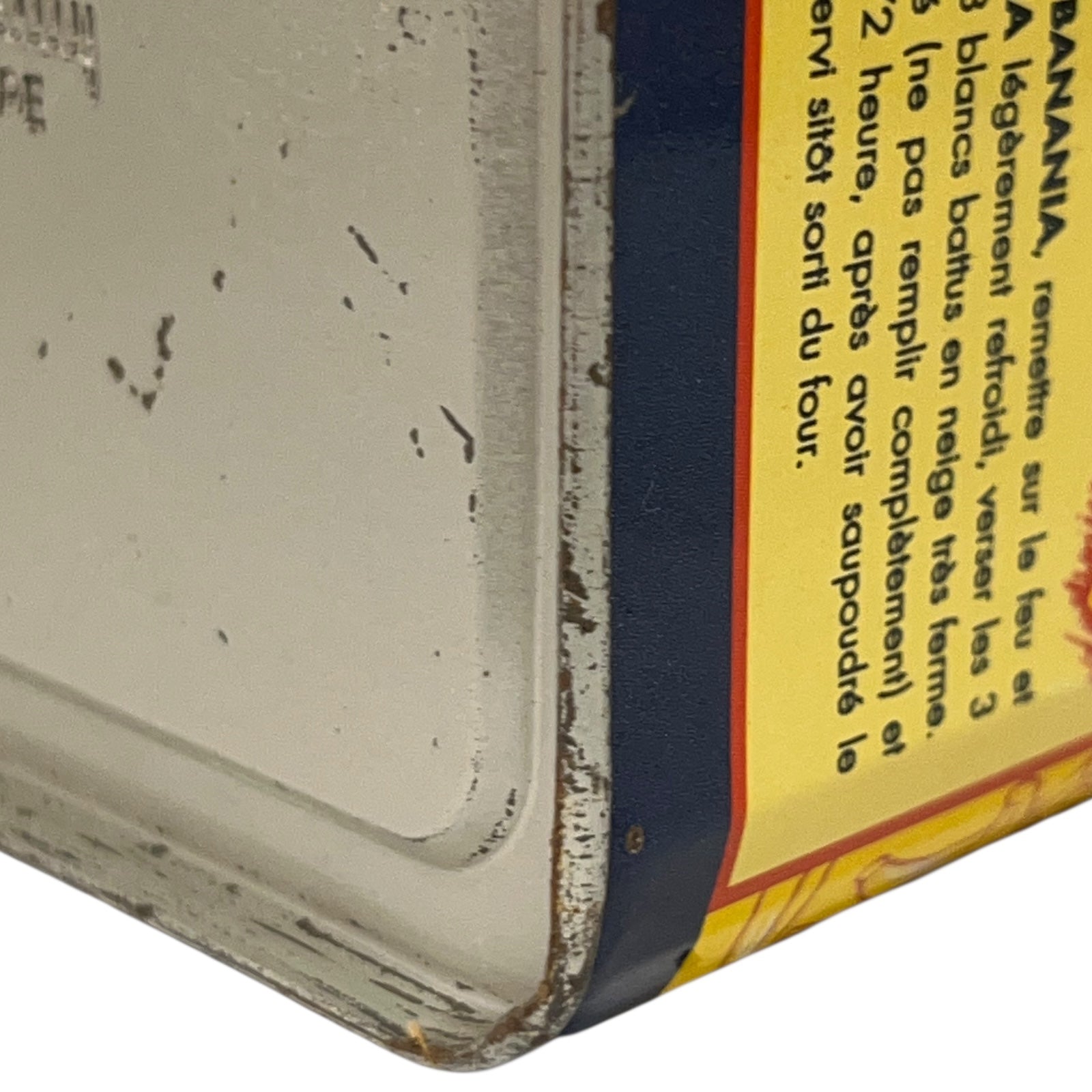 Close-up of a vintage product packaging with text and a banana illustration.