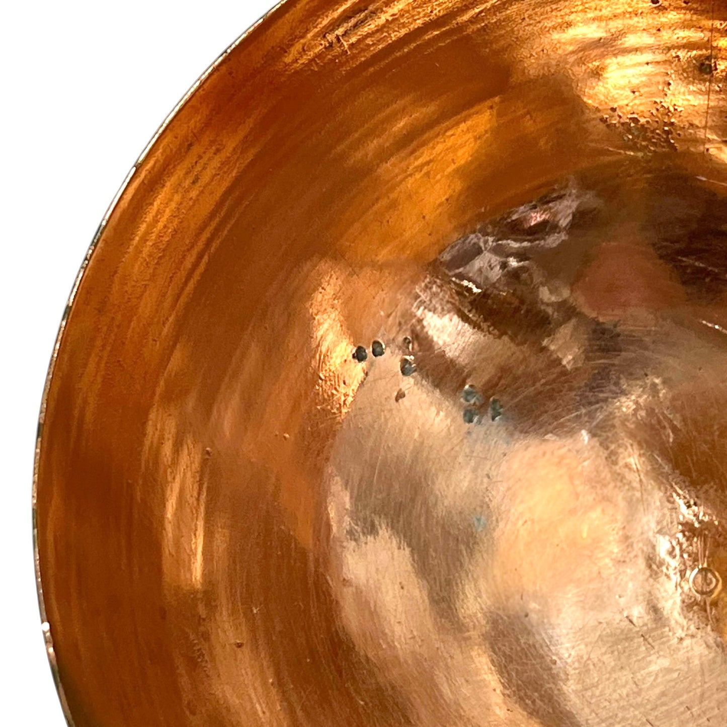 Close up of a French copper handmade ladle on a white background