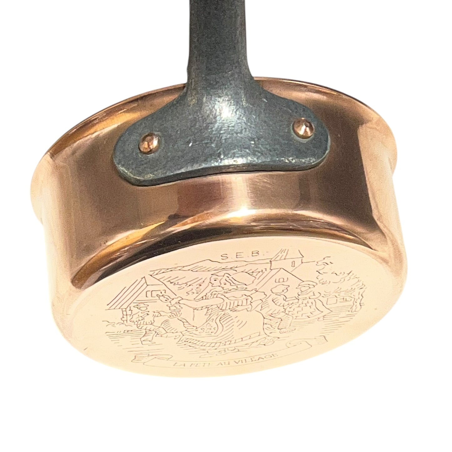 Copper frying pan with engraved design on a white background