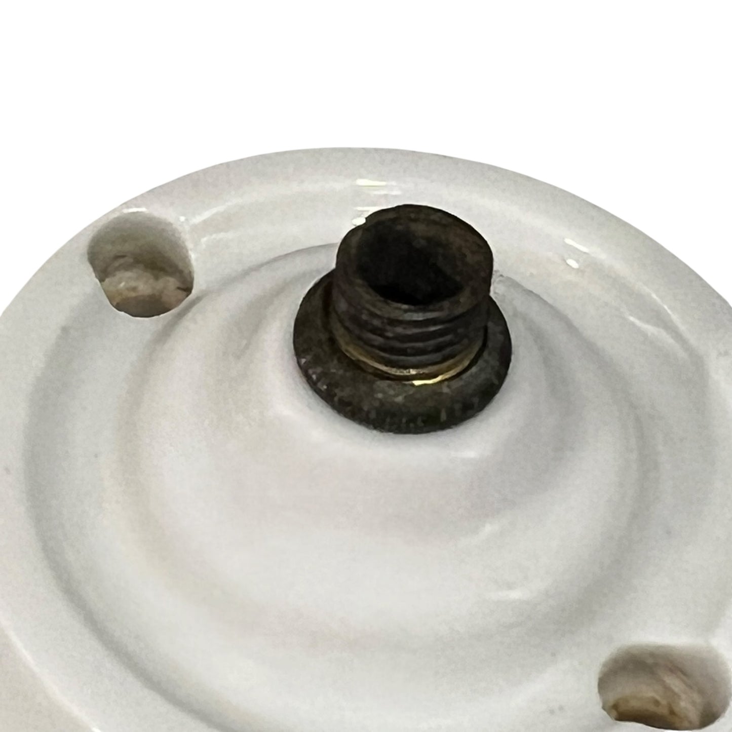 White French porcelain ceiling light rose fitting with a brass screw and 2 screw holes on a white background