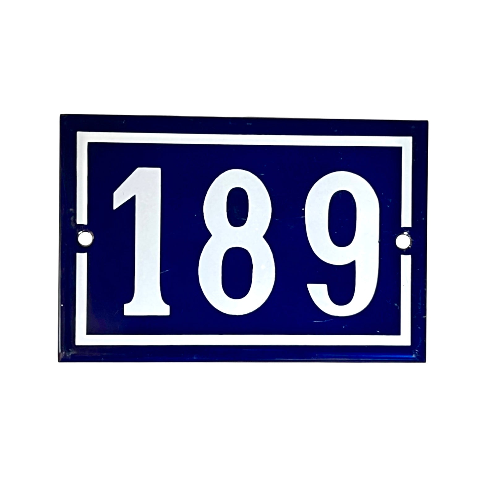 A rectangular blue house number plaque with white border and white numerals '189' on a plain white background.