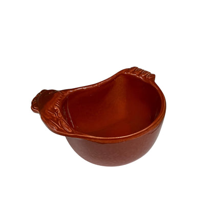 A small reddish-brown ceramic bowl with a textured exterior and a molded handle on one side, shown on a plain white background.