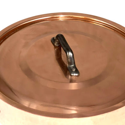 Copper pot lid with a handle on a white background