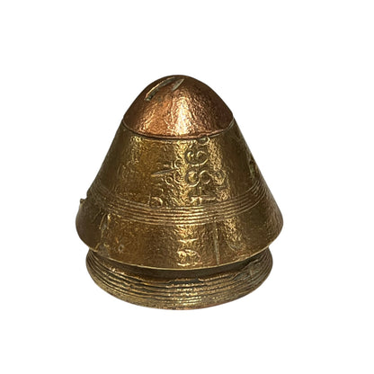 A small metallic bell-shaped object with engraved decorative details, shown on a plain white background.