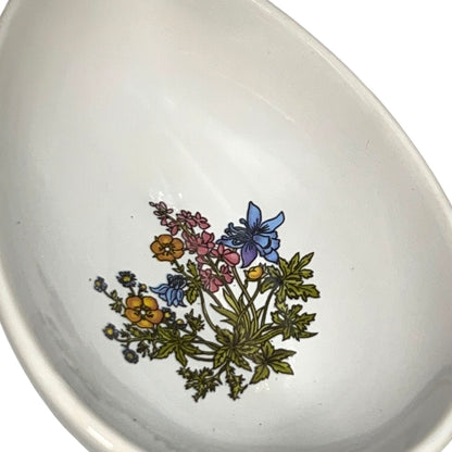 White ceramic bowl with floral design on a white background