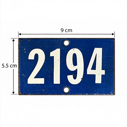 A blue rectangular metal house number plate with white numerals '2194' and dimension arrows showing 9 cm width and 5.5 cm height on a white background.