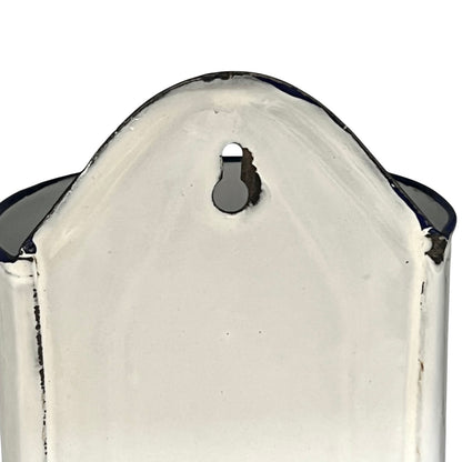 Close up of  French vintage enamel planter with a flat back and a spout on a white background