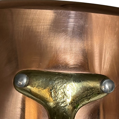 Close up of brass handled copper pan 