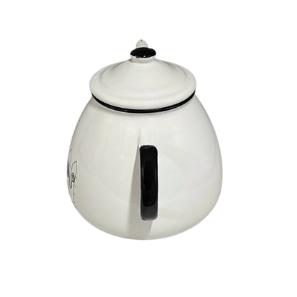 White teapot with black handle and lid on a white background