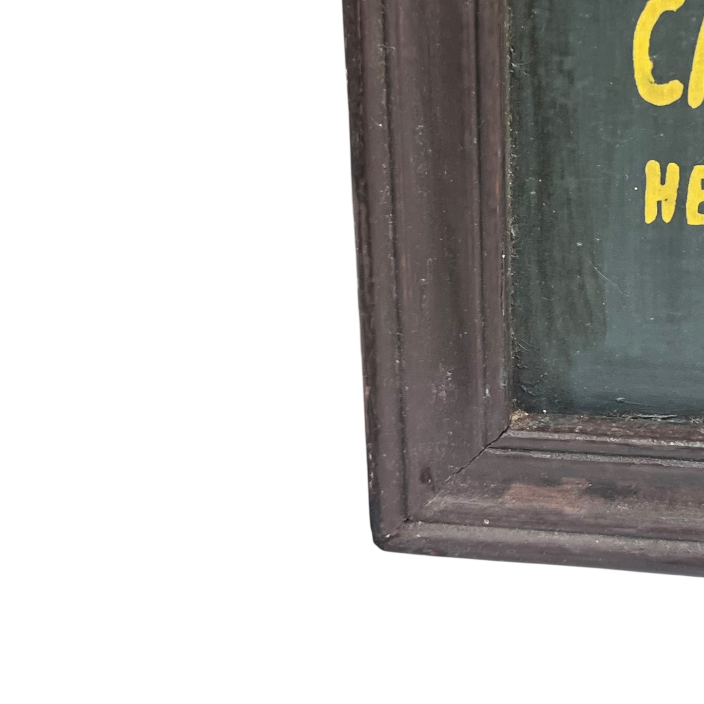 Corner of a framed picture with a dark brown frame and green interior.