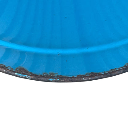 Close up of blue metal bucket with a wooden handle on a white background
