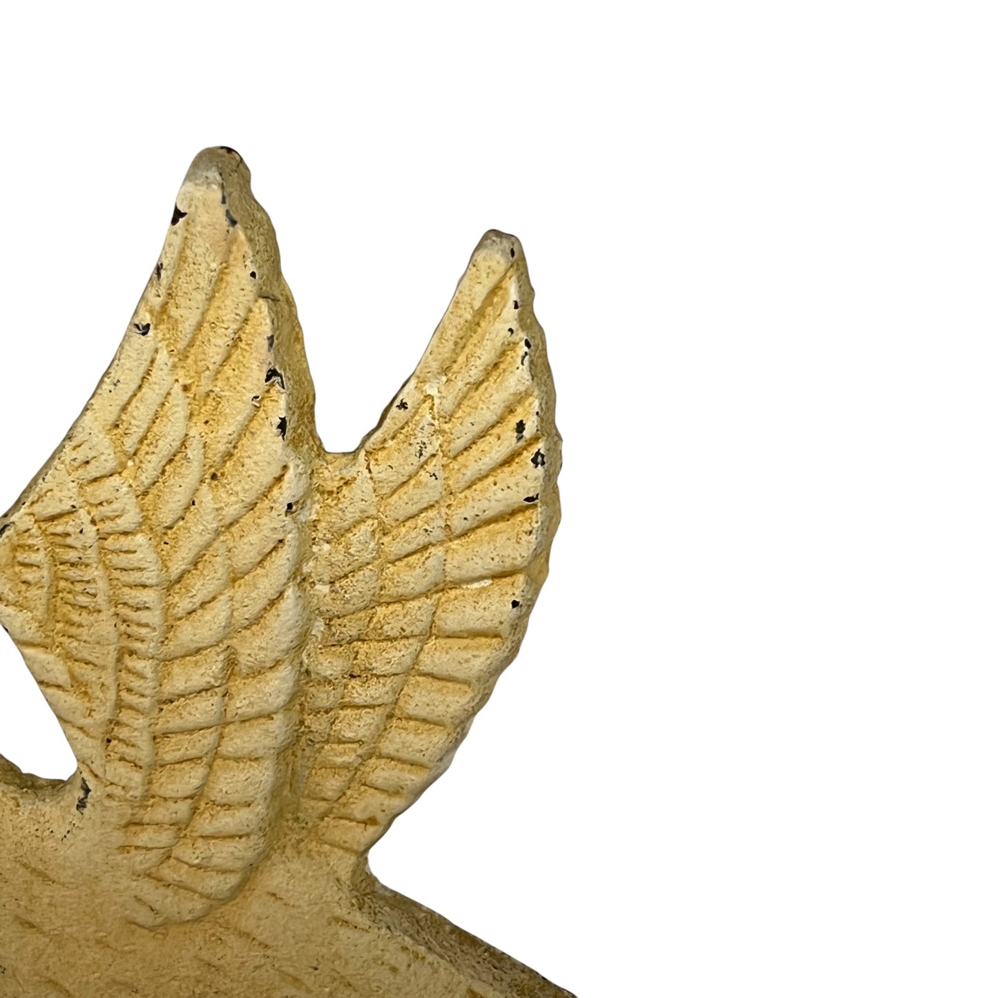 Close-up of a textured winged decorative sculpture in a warm beige stone-like finish, shown against a plain white background.