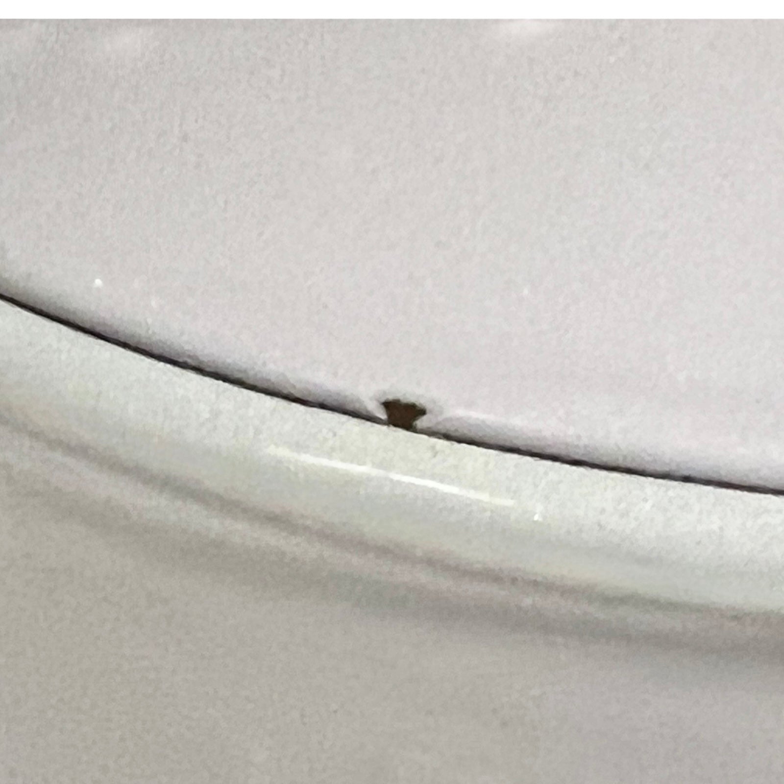 Close up of a Le Creuset pot on a white background