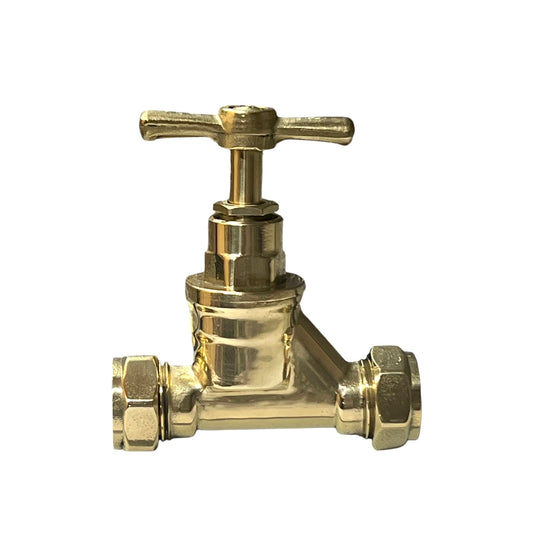 Polished brass sop cock on a white background 