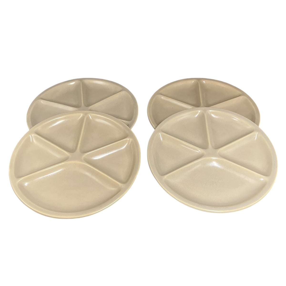 Four round divided plates in a light beige color, arranged in two pairs on a plain white background.