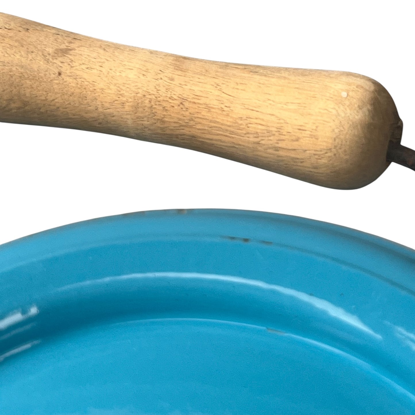 Close up of blue metal bucket with a wooden handle on a white background