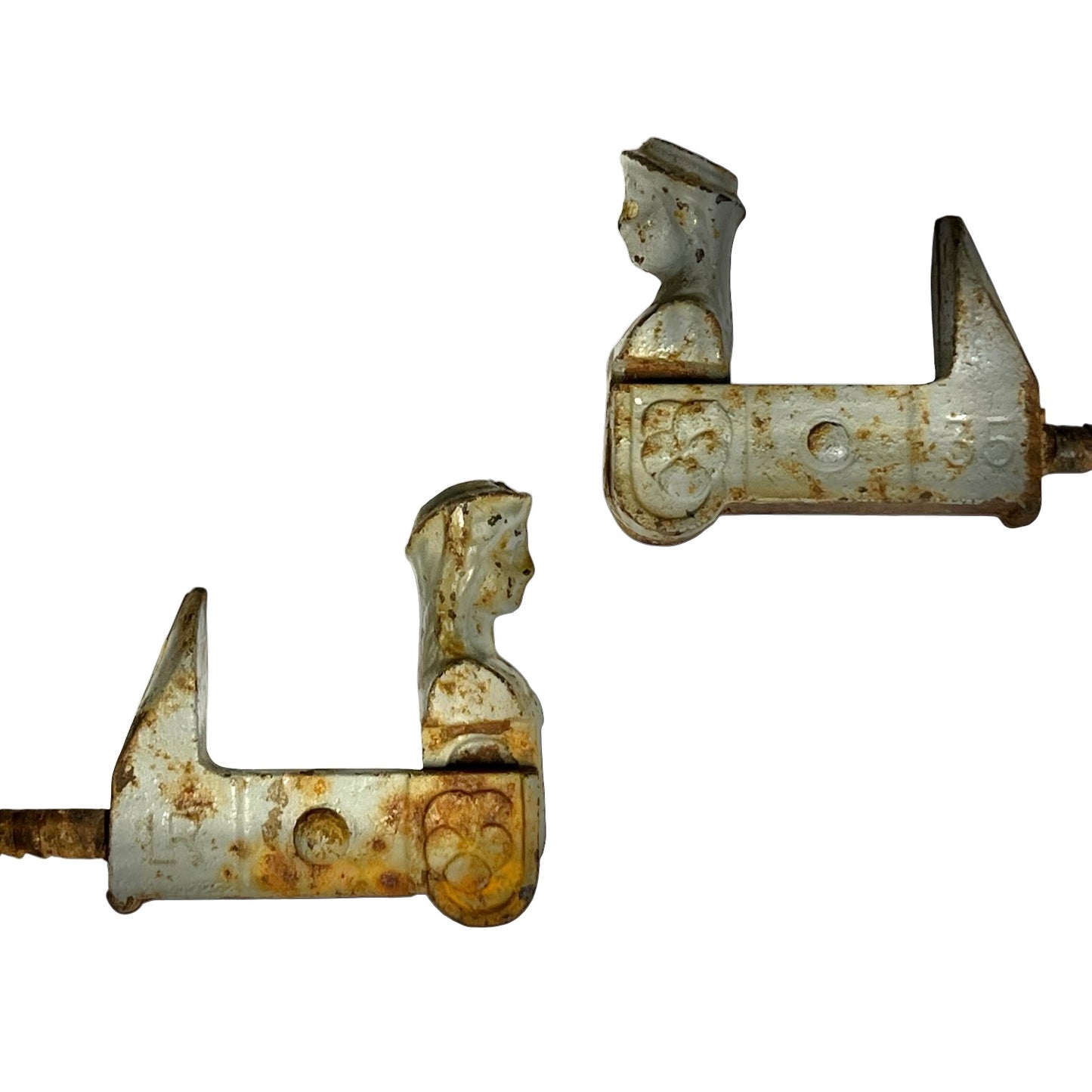 Two vintage metal hardware pieces with a weathered white-painted finish and extensive rust, shown against a plain white background.