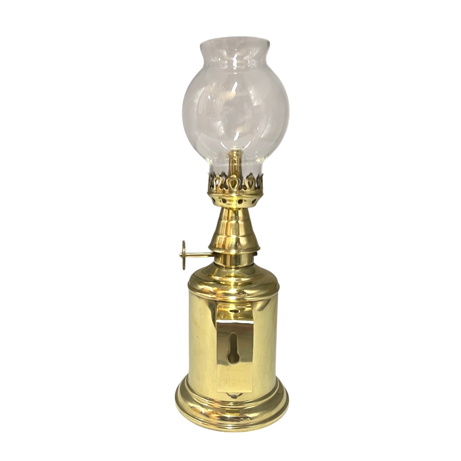 Brass oil lamp with clear glass shade on a white background