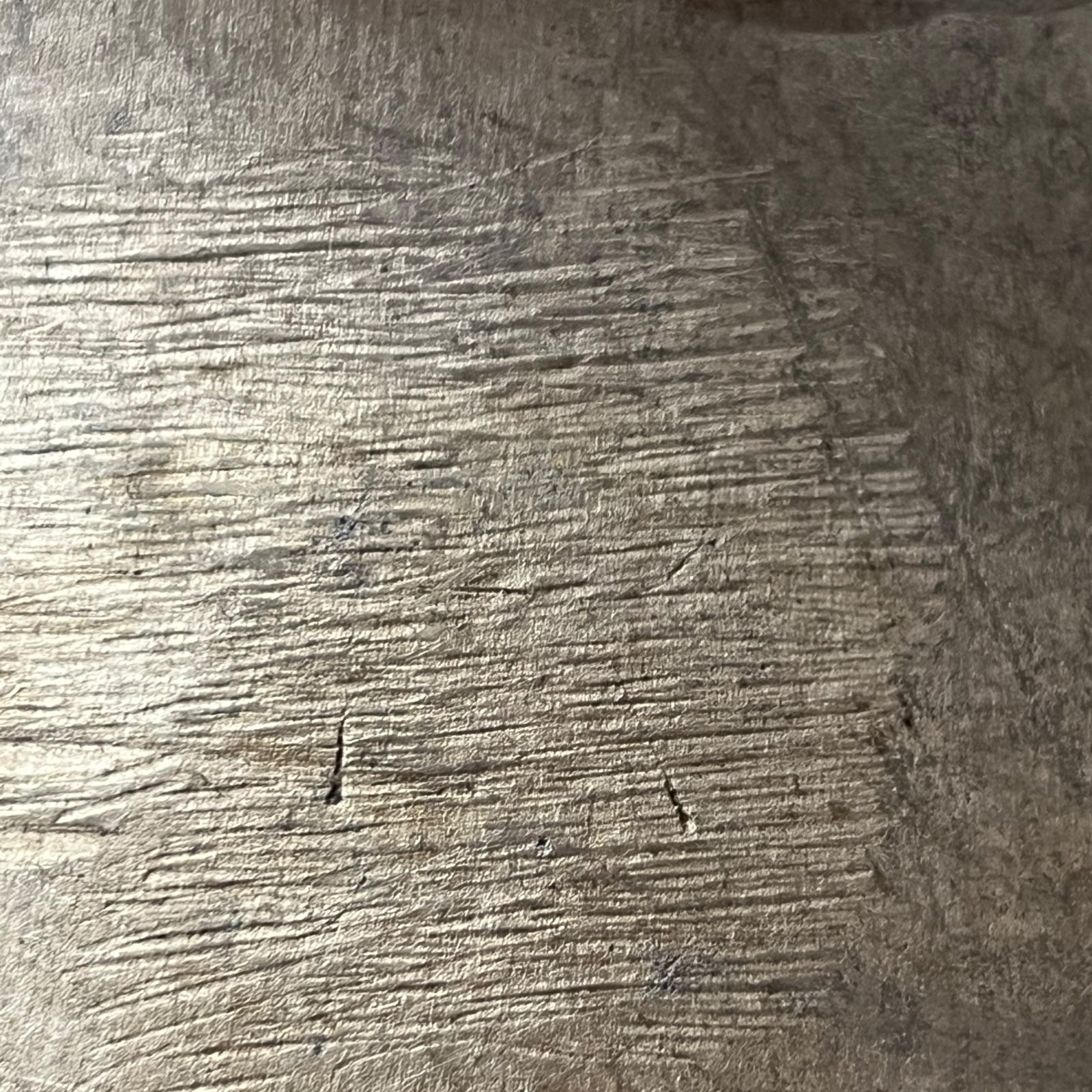 Close-up of a textured metal surface of milk churn