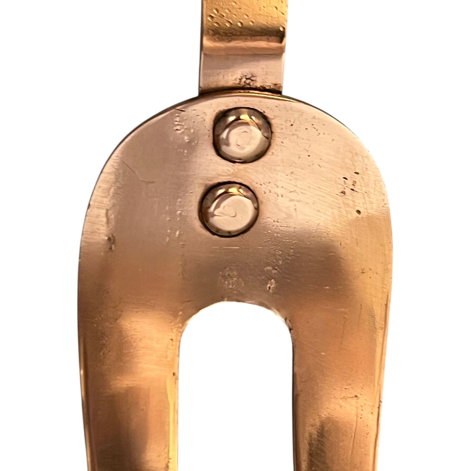 Close-up of a copper fork on a white background