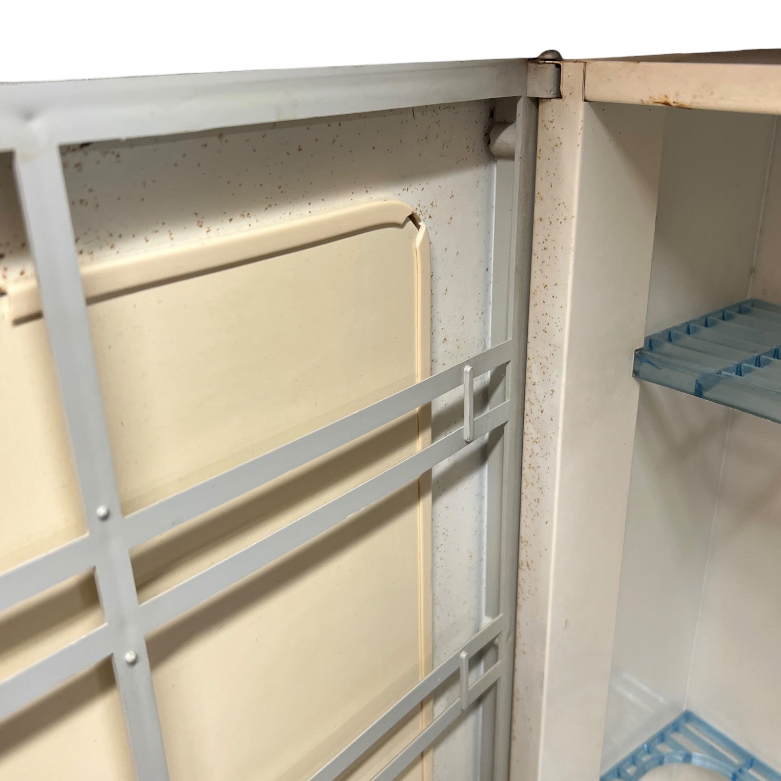 close up of a vintage metal bathroom cabinet inside view on a white background